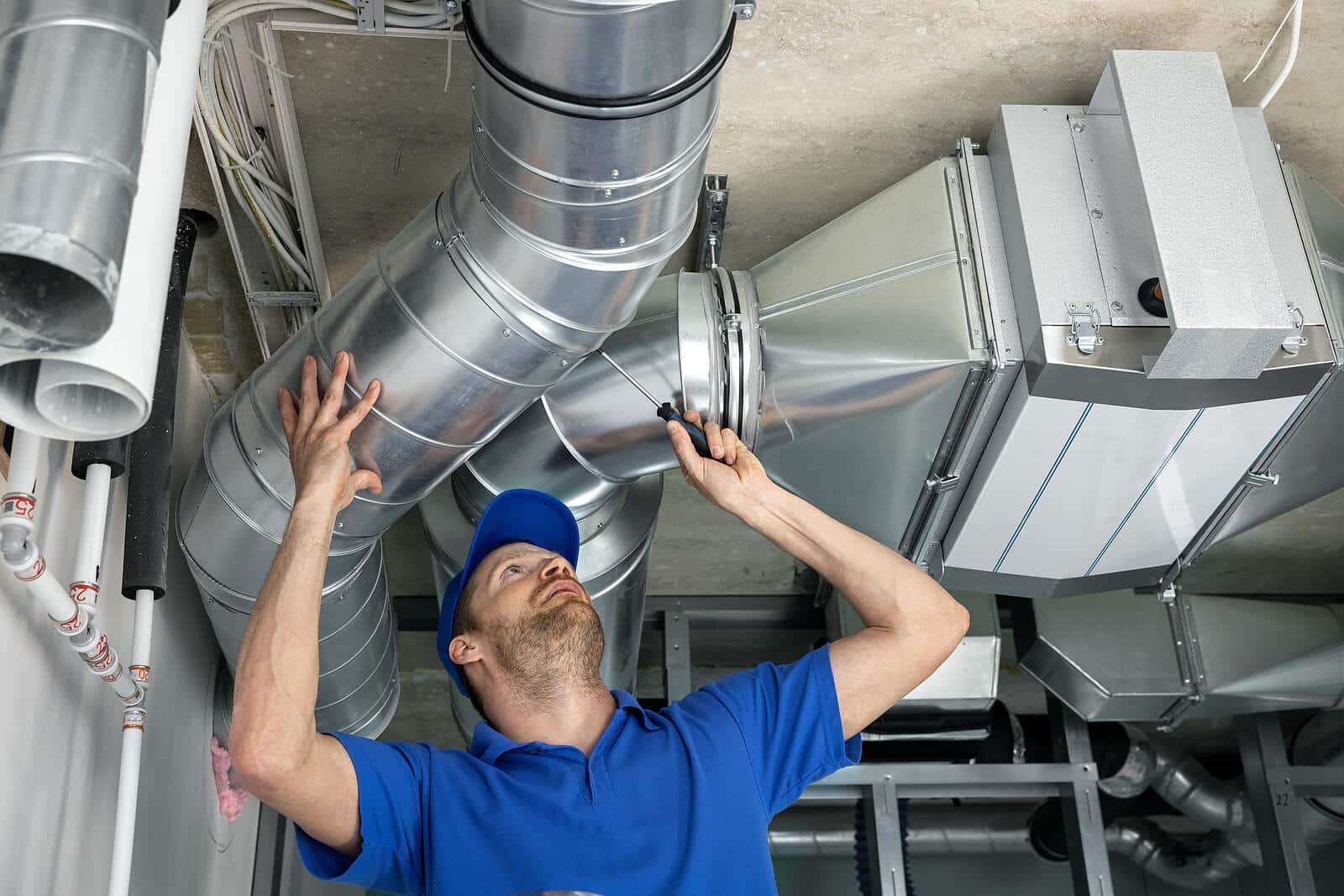 HVAC technician inspecting and repairing air ducts in Millbrae