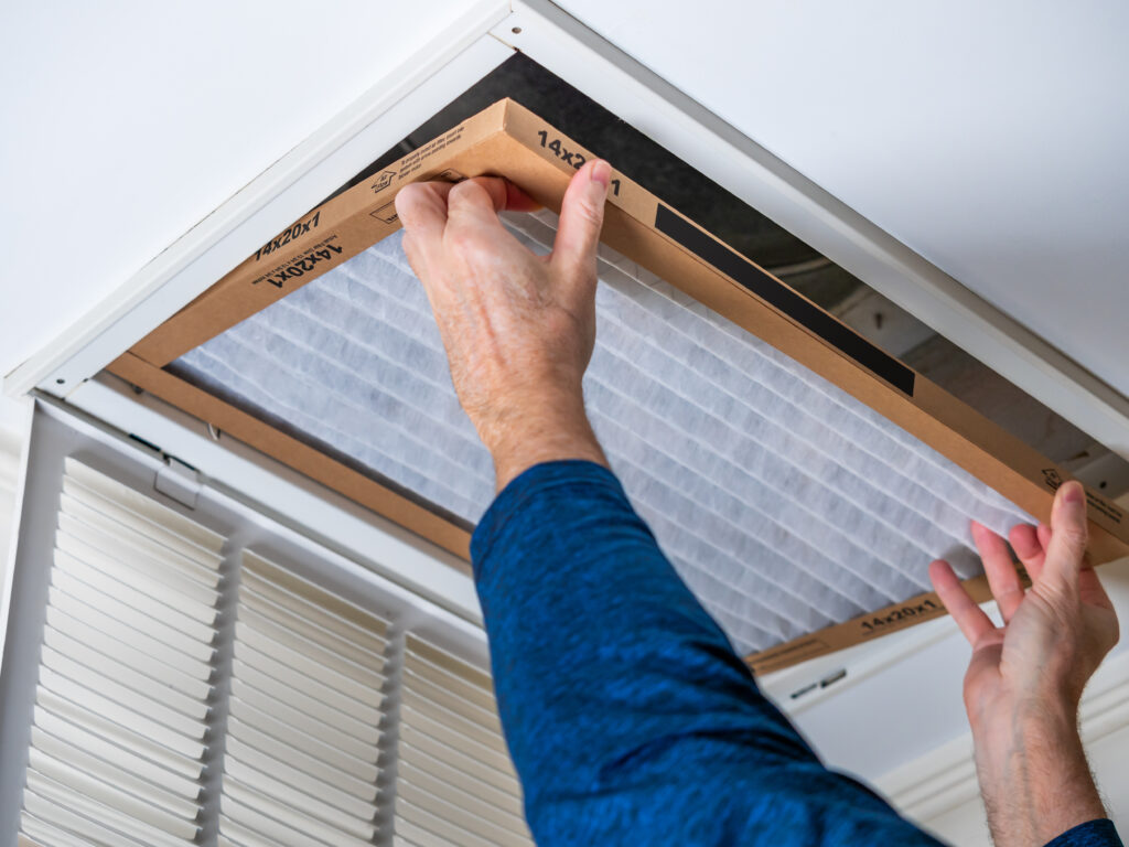 HVAC technician replacing a home air filter in Millbrae