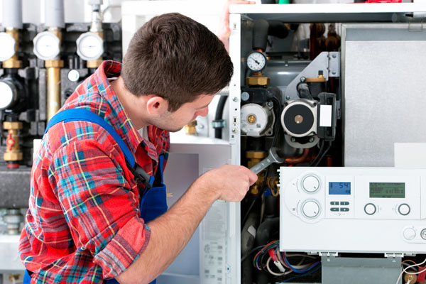 Heating technician repairing boiler controls in Millbrae
