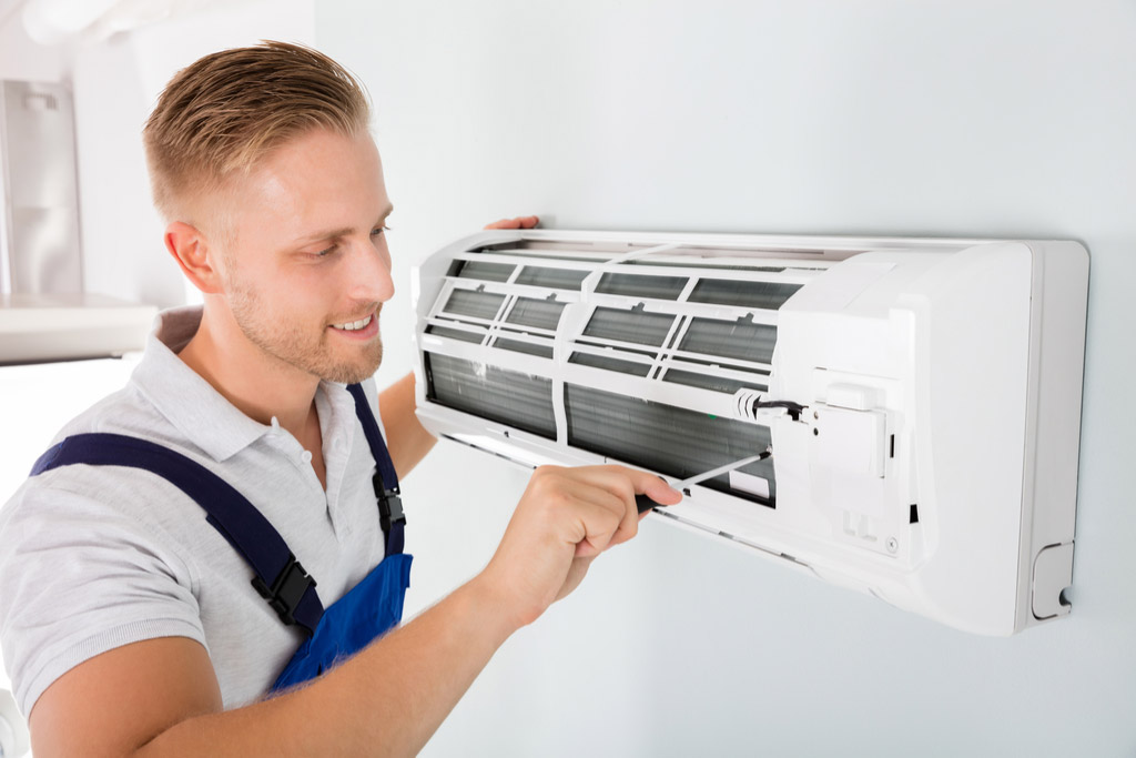 HVAC technician maintaining a ductless air conditioner in Millbrae