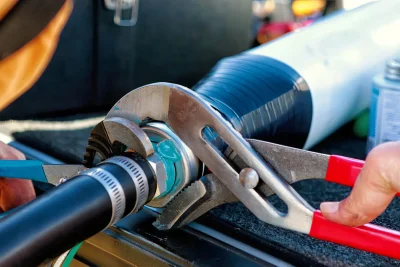 Technician repairing an industrial pipe connection in Millbrae
