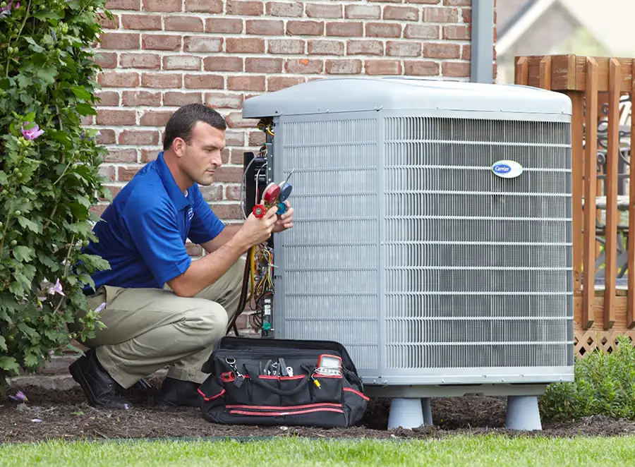 HVAC technician inspecting an outdoor AC unit in Millbrae